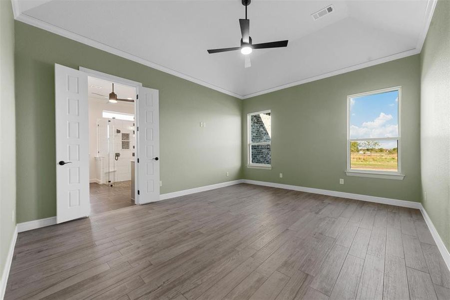 Unfurnished room featuring ceiling fan, crown molding, and hardwood / wood-style flooring