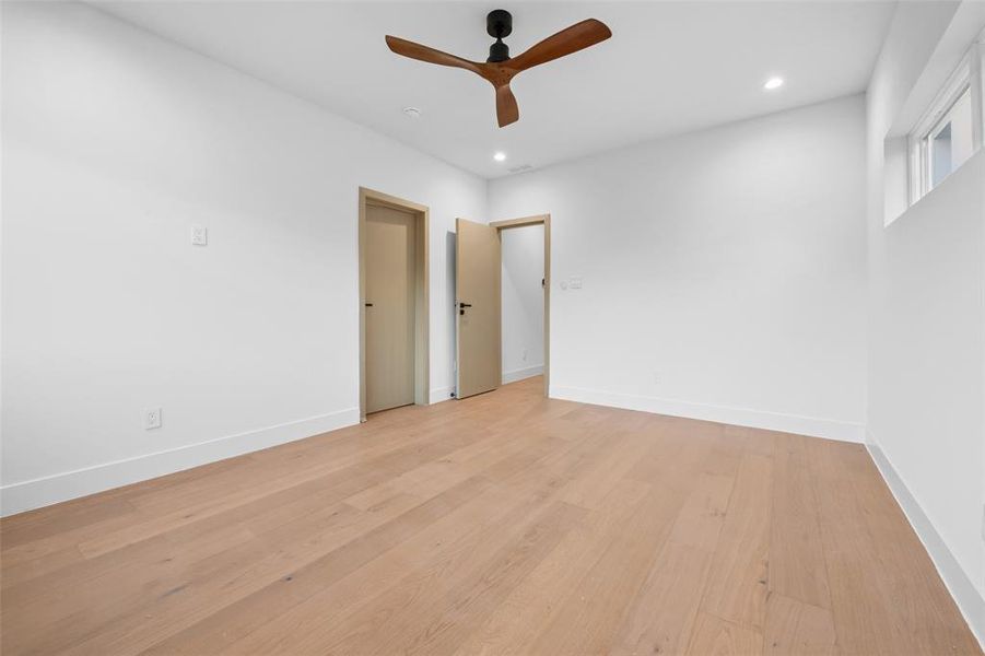 Spare room with light wood-style floors, a ceiling fan, and recessed lighting