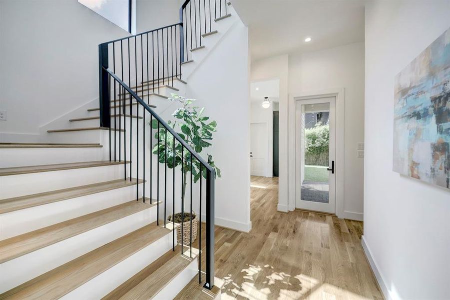 Gorgeous custom-stained natural white oak hardwood flooring throughout this stunning residence