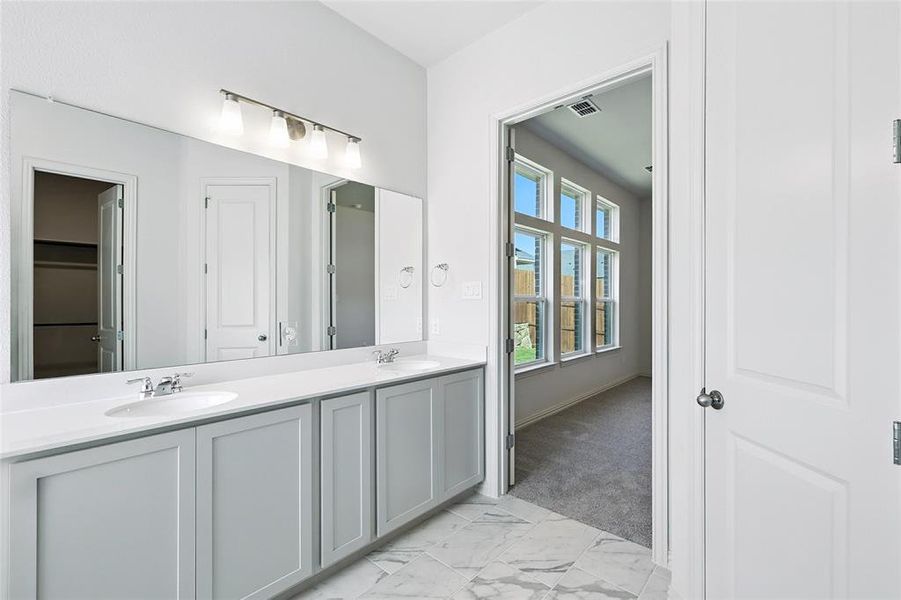Full bath with double vanity and marble look tiles Full bath with double vanity and marble look tiles