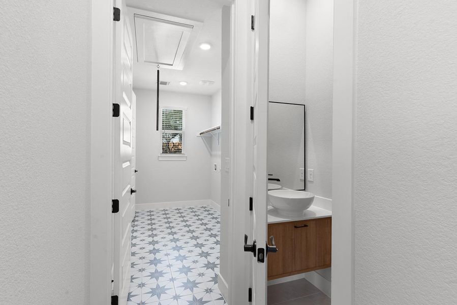 A clever laundry room design with star-patterned tile flooring creates an appealing space.