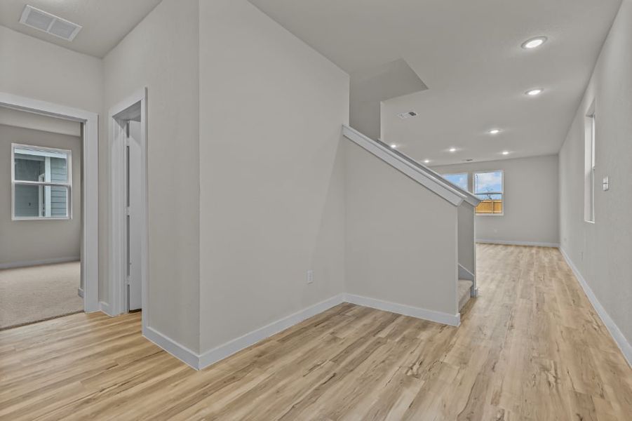 A room with a wood floor and white walls.