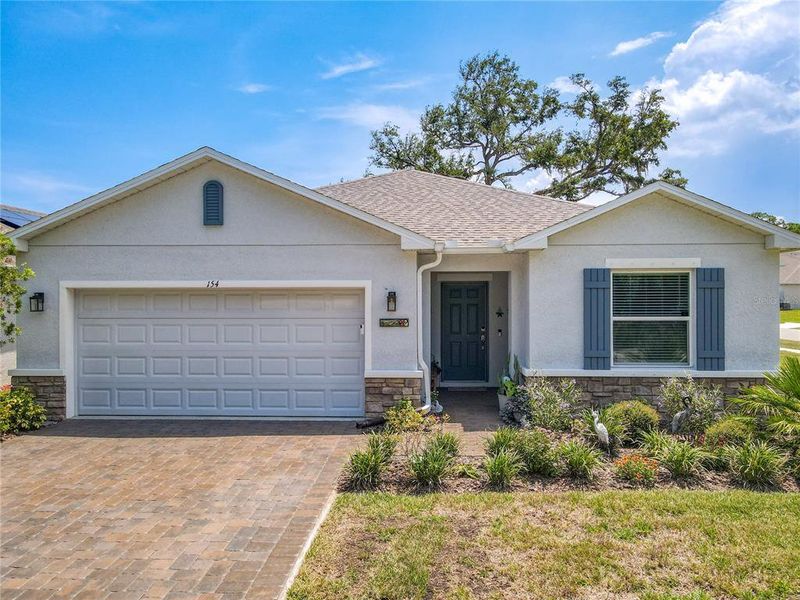 Front exterior of a new home in Riverfront, Edgewater, FL, highlighting curb appeal (Image 23).
