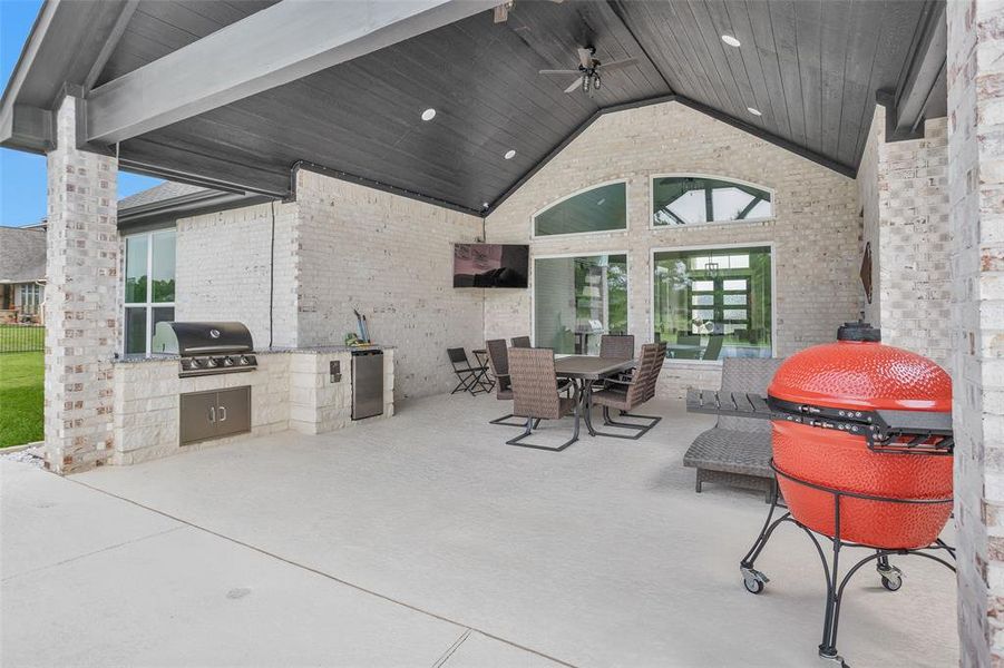 Outdoor kitchen with gas grill, and TV wired in.