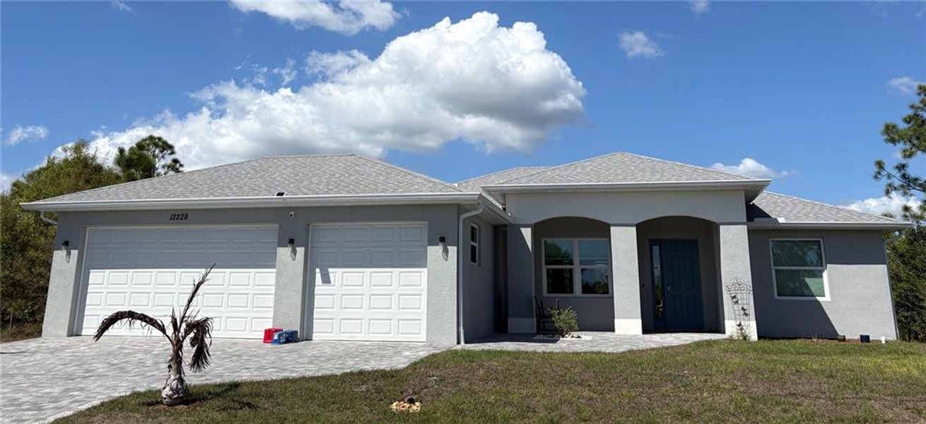 Front exterior of a new home in , Port Charlotte, FL, highlighting curb appeal (Image 16).