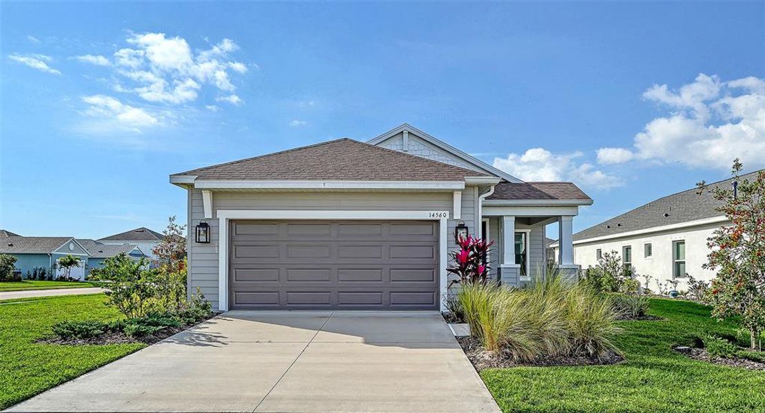 Front exterior of a new home in Canoe Creek, Parrish, FL, highlighting curb appeal (Image 18).