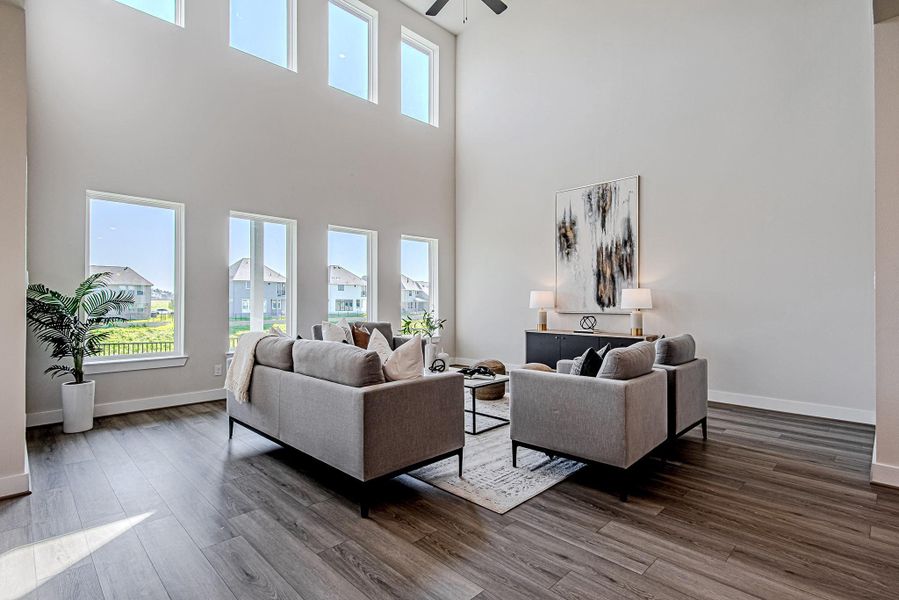 Spacious living room with soaring ceilings and a wall of windows
