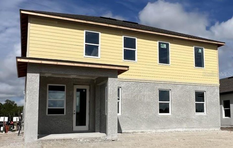 Front exterior of a new home in Hawks Run, Kissimmee, FL, highlighting curb appeal (Image 11).
