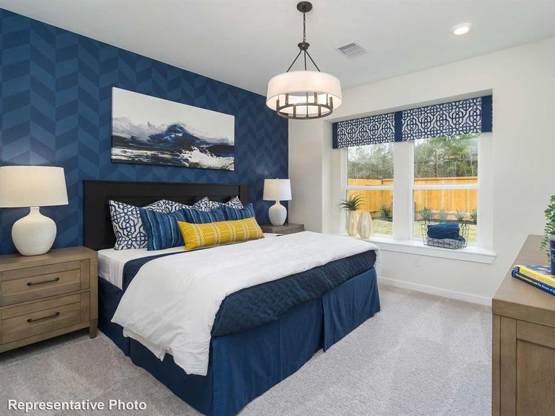 Bedroom featuring light carpet and wallpapered walls