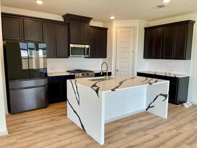 Kitchen with island. Refrigerator included if desired by Tenant. Kitchen with island. Refrigerator included if desired by Tenant.