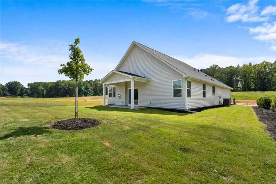 A spacious green lawn surrounds the rear exterior A spacious green lawn surrounds the rear exterior