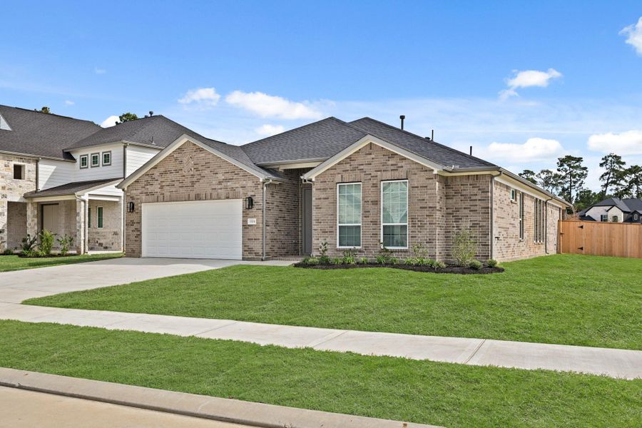 Front exterior of a new home in Barton Creek Ranch, Conroe, TX, highlighting curb appeal (Image 22).