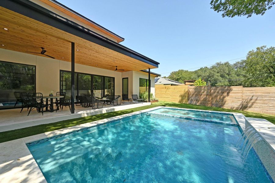 View of swimming pool featuring a patio, a fenced backyard, ceiling fan, and outdoor dining space