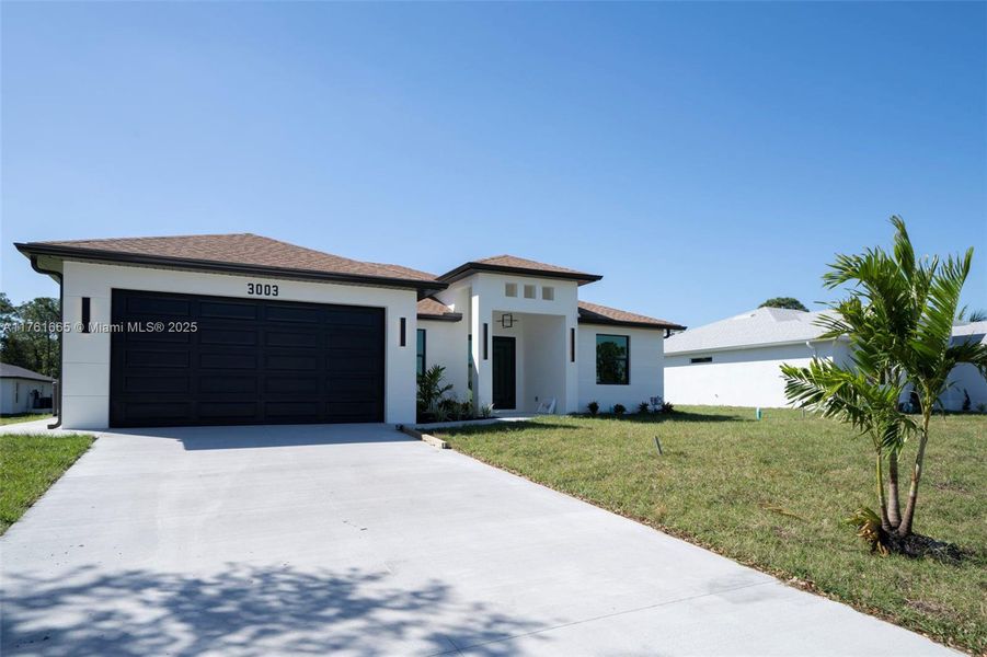 Front exterior of a new home in , Lehigh Acres, FL, highlighting curb appeal (Image 14).