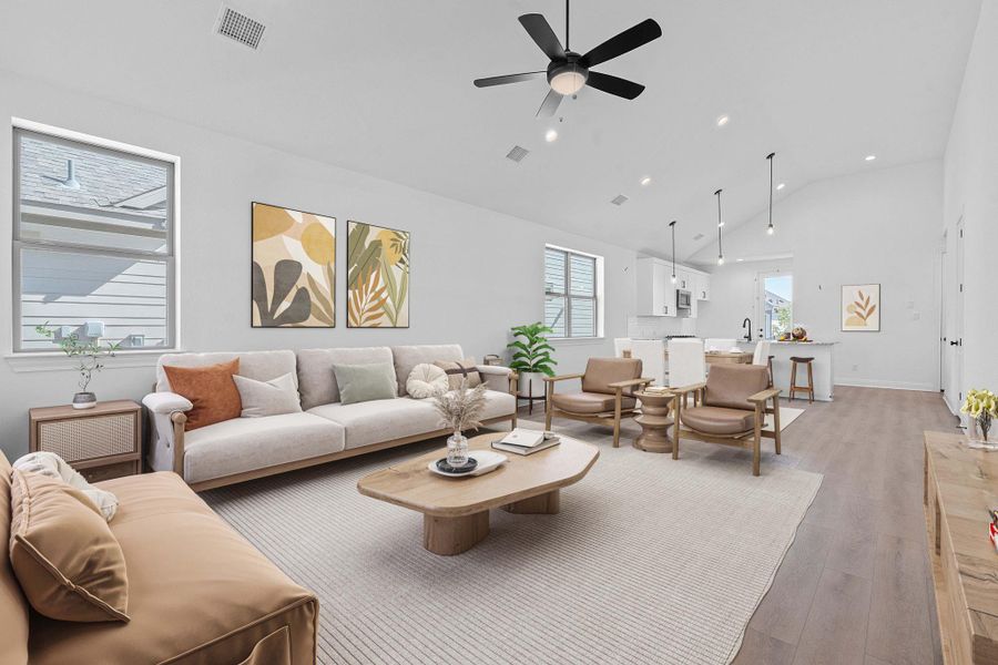 Living room featuring high vaulted ceiling, light wood finished floors, recessed lighting, and ceiling fan Living room featuring high vaulted ceiling, light wood finished floors, recessed lighting, and ceiling fan