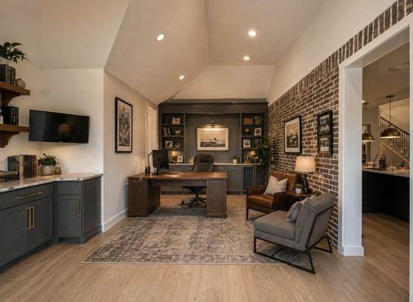 **Virtually staged** Transform your extra room into a stylish, multifunctional office with this virtually staged space, featuring sleek cabinetry, cozy seating, and a warm, inviting ambiance perfect for productivity and relaxation.