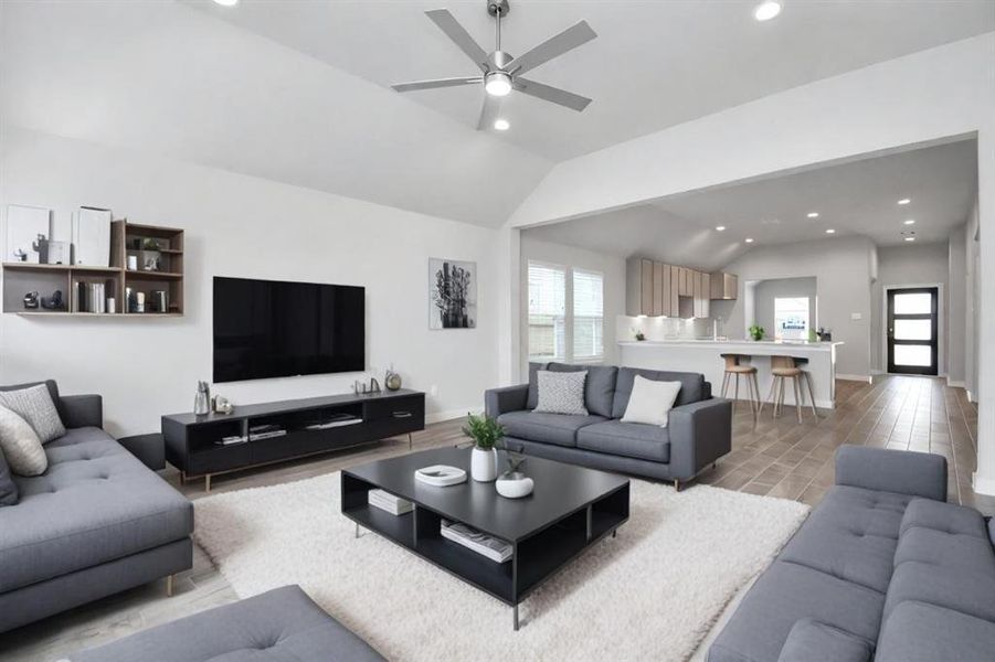 Gather your loved ones and guests in the welcoming living room! Enjoy the spaciousness created by lofty high ceilings, complemented by the glow of recessed lighting and the gentle breeze from a stylish ceiling fan. Representation photo. Actual colors and selections may vary.