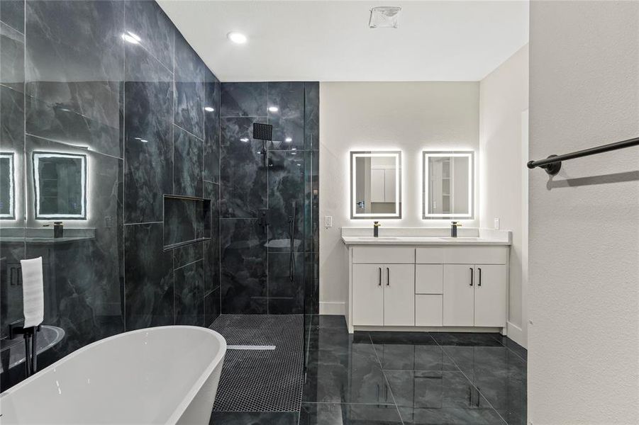 Bathroom with a soaking tub, double vanity, a marble finish shower, and recessed lighting