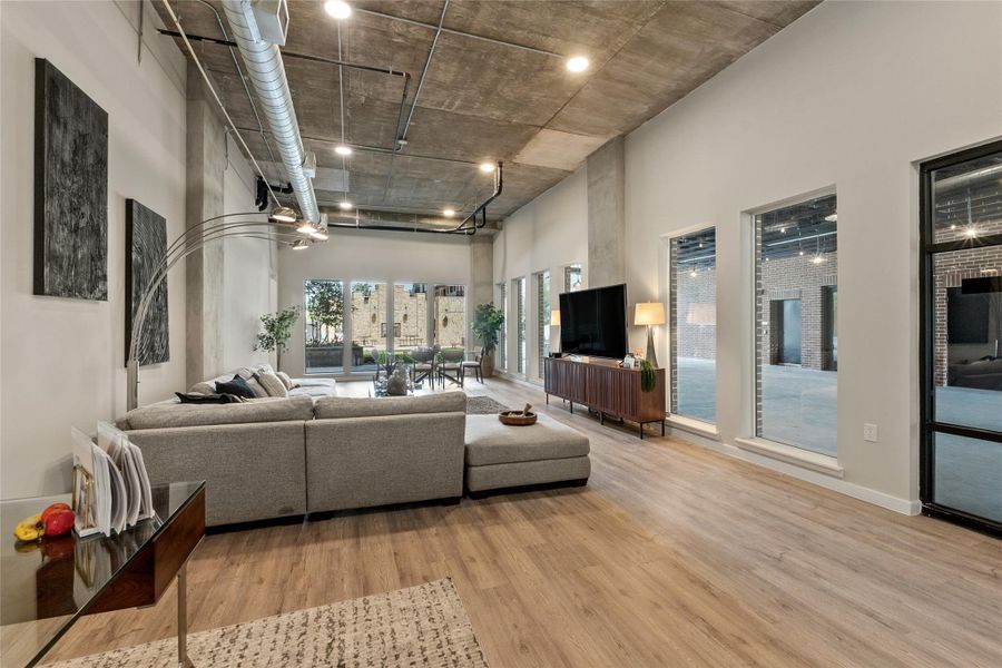 Living room featuring wood finished floors and a towering ceiling