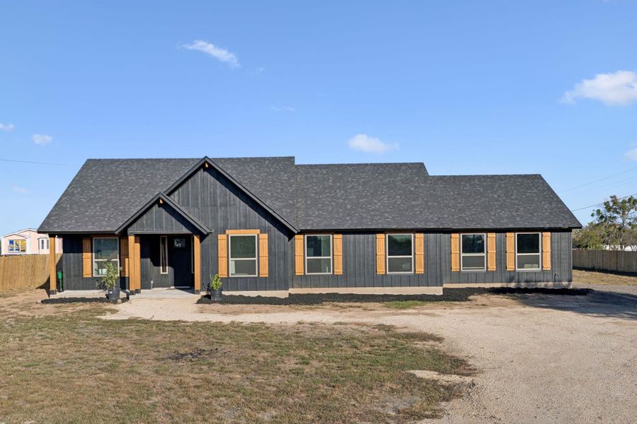 Modern inspired farmhouse featuring covered porch and a shingled roof Modern inspired farmhouse featuring covered porch and a shingled roof