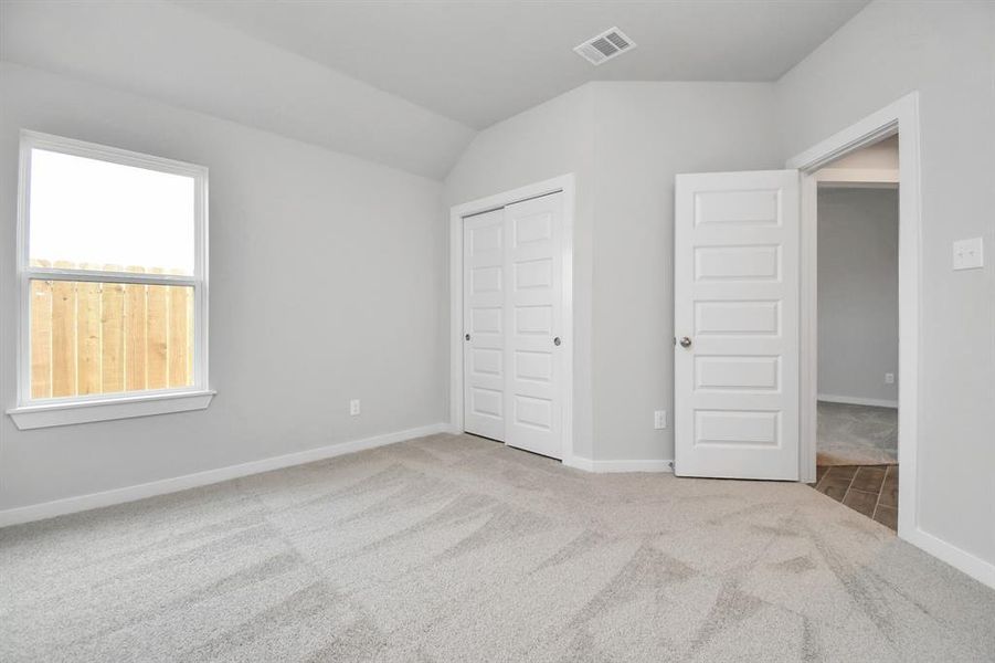 Generously sized secondary bedrooms featuring spacious closets, soft and inviting carpeting underfoot, large windows allowing plenty of natural light, and the added touch of privacy blinds for your personal retreat.