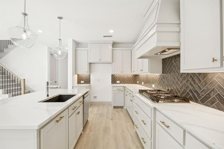 Gorgeous cabinetry, beautiful counter tops and contemporary stainless steel come together to create a chefs dream kitchen!
