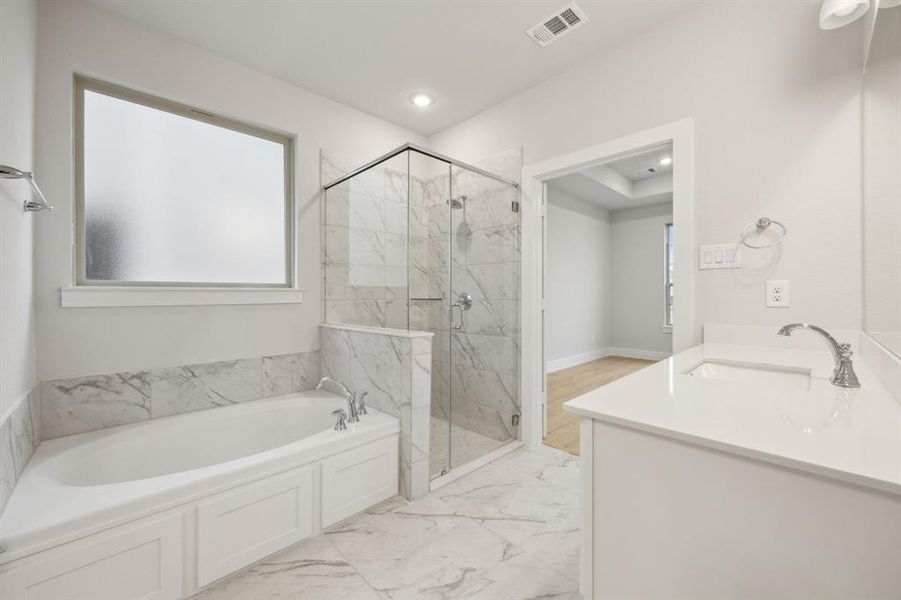 Bathroom featuring independent shower and bath and vanity