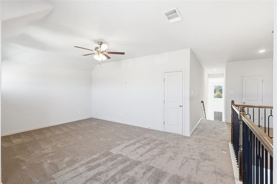 Bonus room featuring light colored carpet, a ceiling fan, and recessed lighting