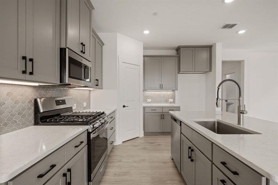 Featuring stainless appliances and thoughtful design elements, this kitchen is one for the books!