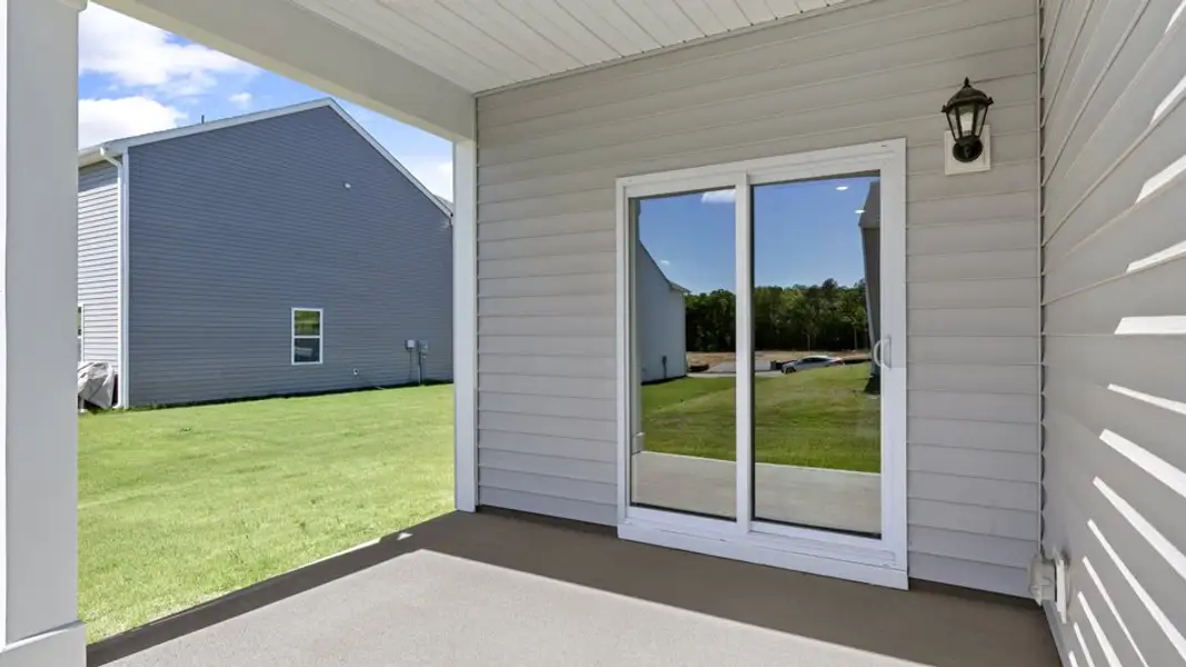 Exterior details and patio area of a home in The Landing at Winston Pointe, Clayton (Image 4). Exterior details and patio area of a home in The Landing at Winston Pointe, Clayton (Image 4).