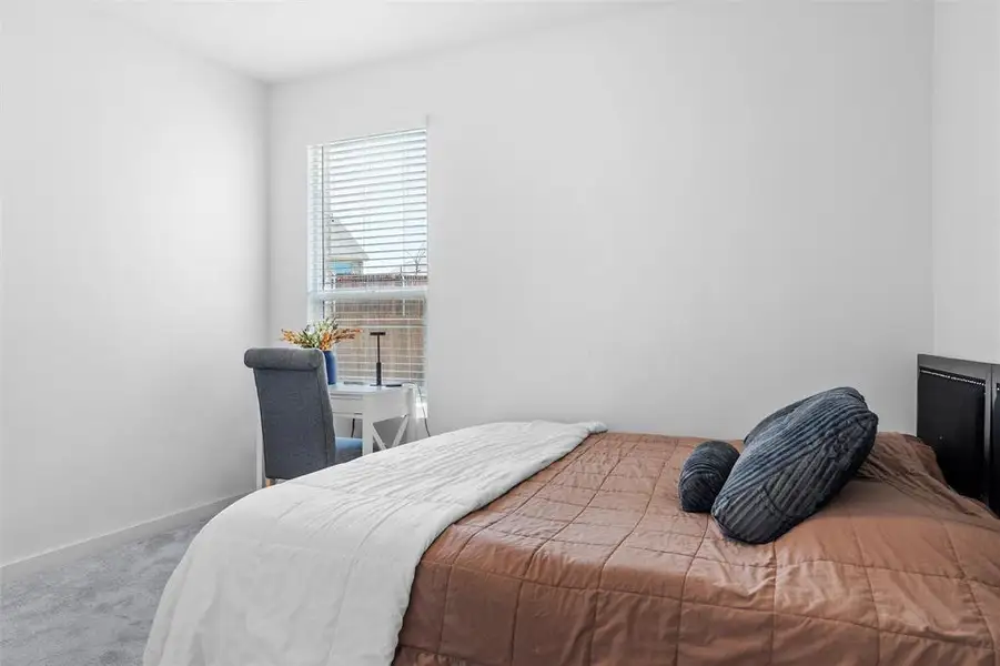 Carpeted bedroom with baseboards Carpeted bedroom with baseboards