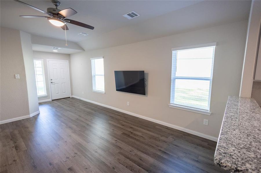 Living room with abundant natural light from large windows.