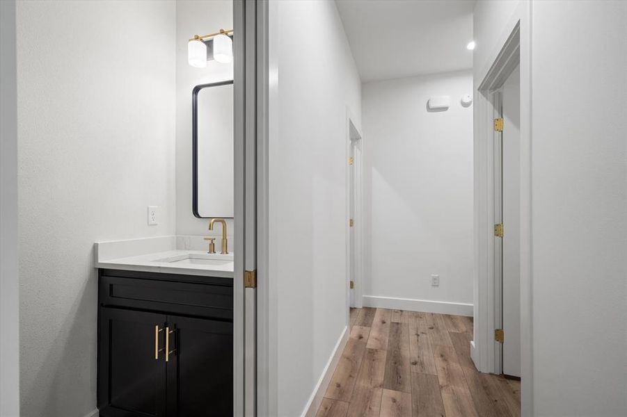 Half bath featuring vanity and light wood finished floors
