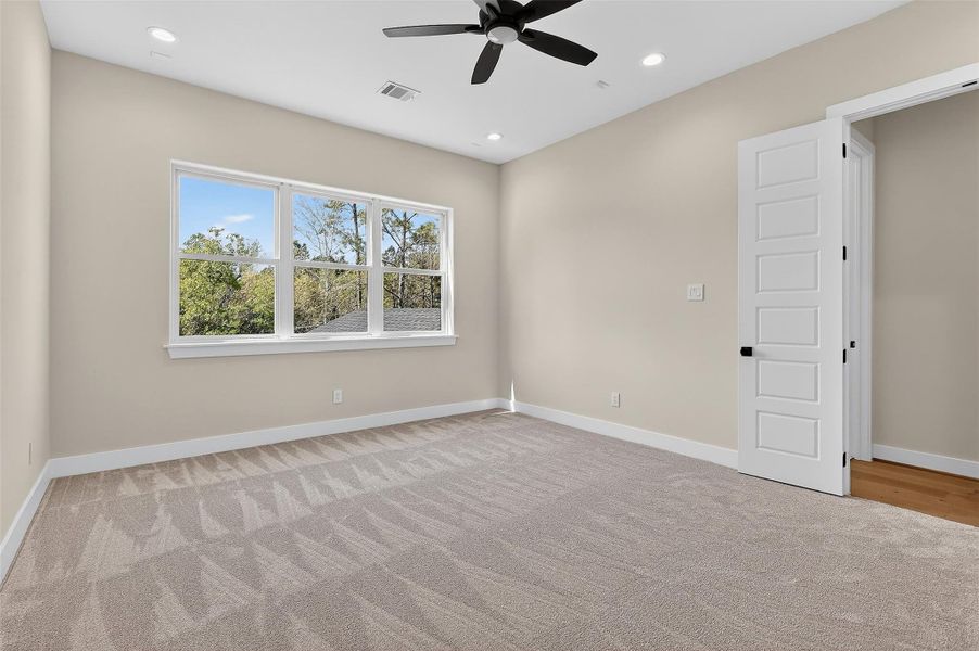 A serene bedroom with a clean aesthetic and abundant natural light.
