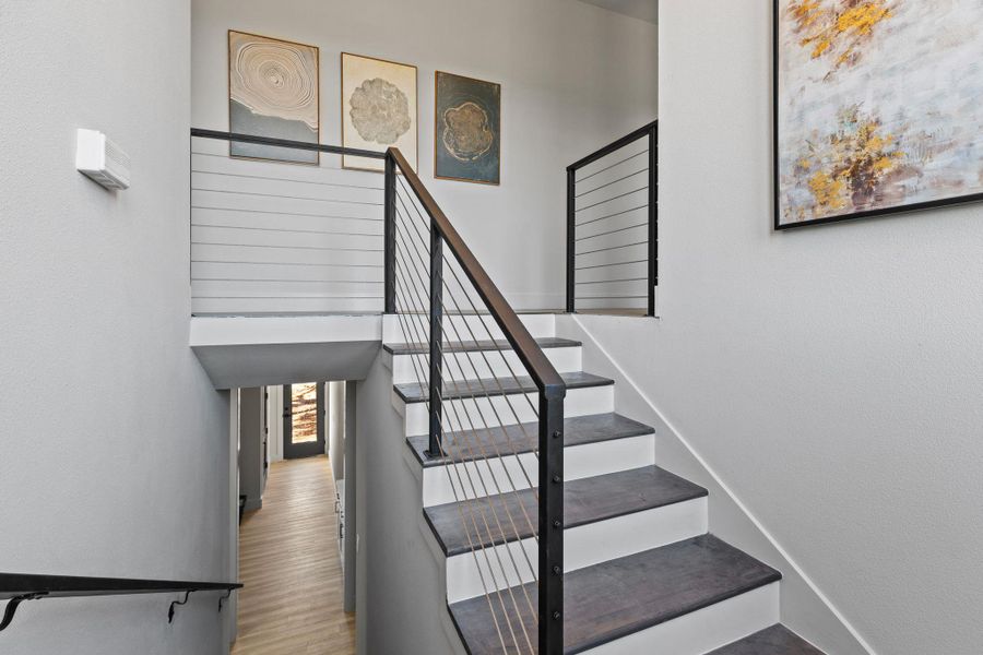 Stairs featuring wood finished floors and baseboards