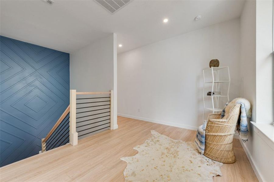 Sitting room with light hardwood / wood-style flooring