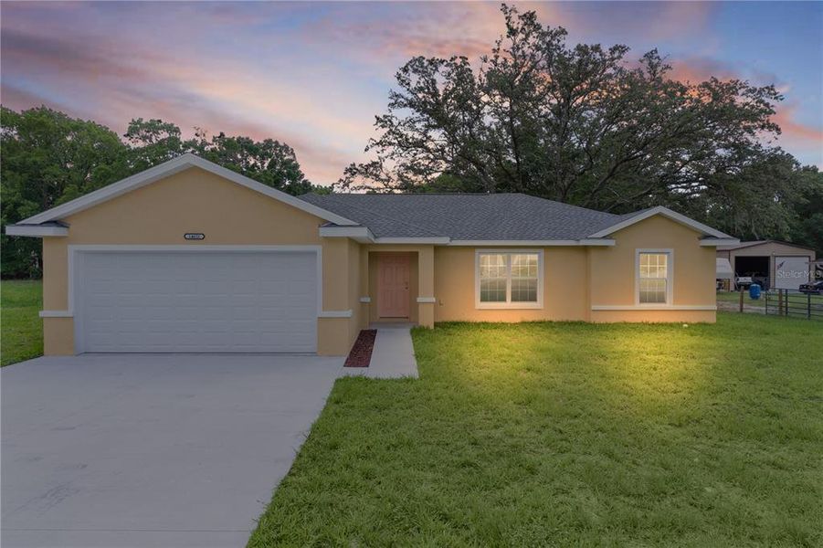 Front exterior of a new home in , Summerfield, FL, highlighting curb appeal (Image 17).