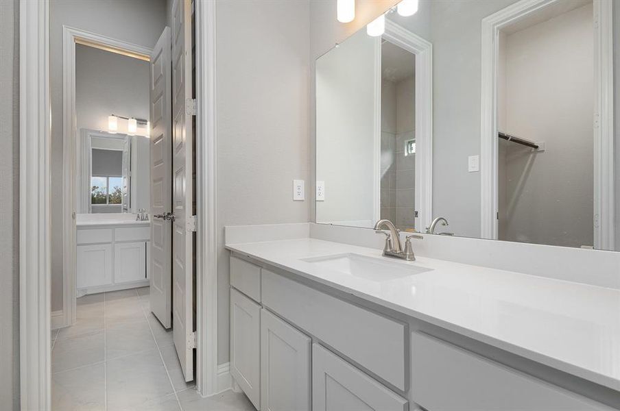 Bathroom featuring tile patterned flooring and vanity