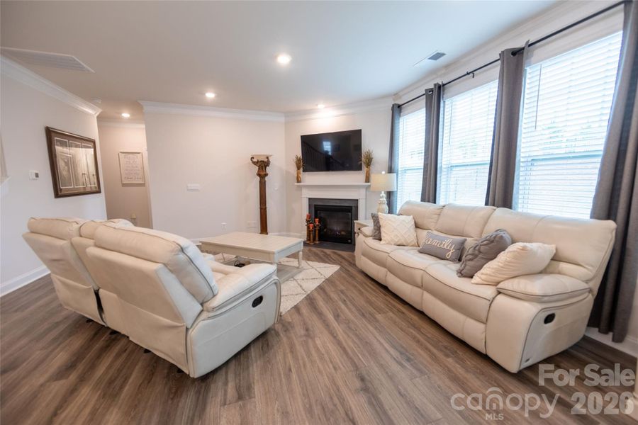 Living room with a charming gas fireplace and abundant natural light.