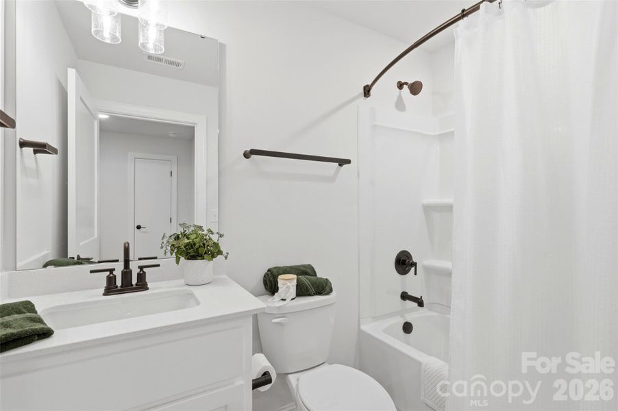 Bright upstairs bath with a clean, modern design and stylish finishes throughout.