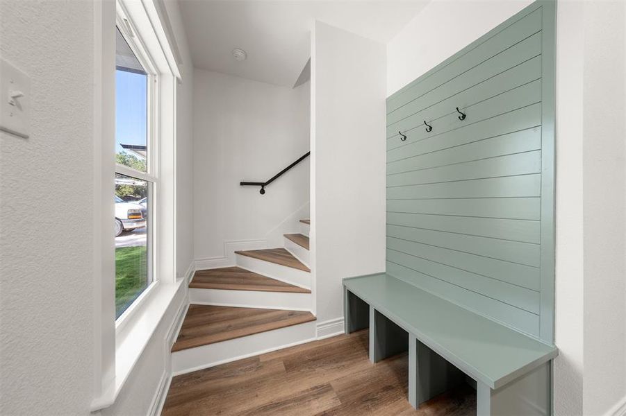 Mudroom with dark wood-style floors and baseboards Mudroom with dark wood-style floors and baseboards