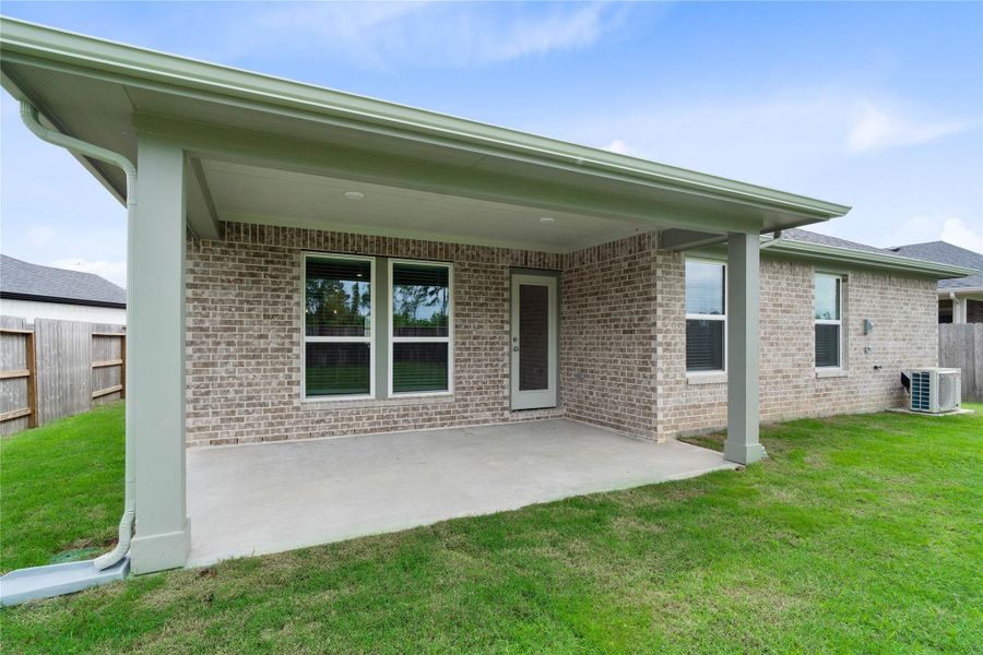 The spacious covered patio offers a tranquil outdoor retreat, perfectly designed for savoring your quiet morning coffee or unwinding during peaceful evening relaxation.