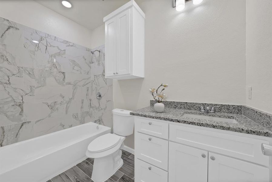 Bathroom with vanity and shower / tub combination