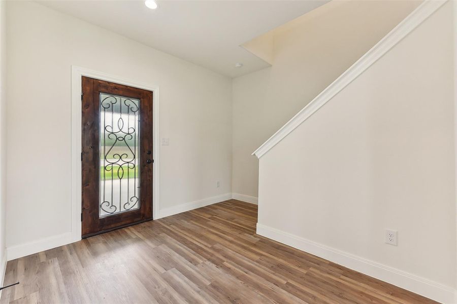 Entryway with wood look floors, baseboards, and recessed lighting Entryway with wood look floors, baseboards, and recessed lighting