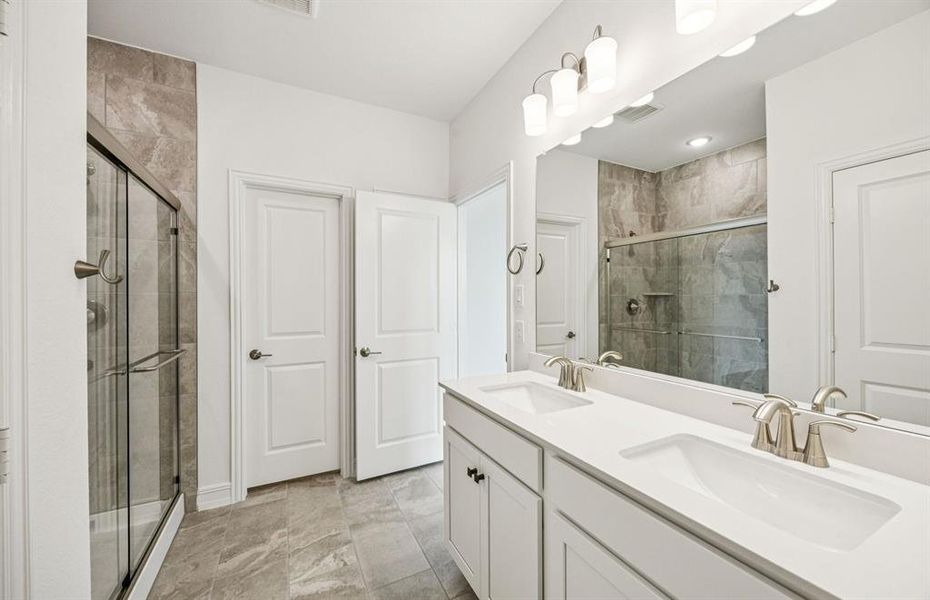 Deep walk in shower in owner's suite *Real home pictured