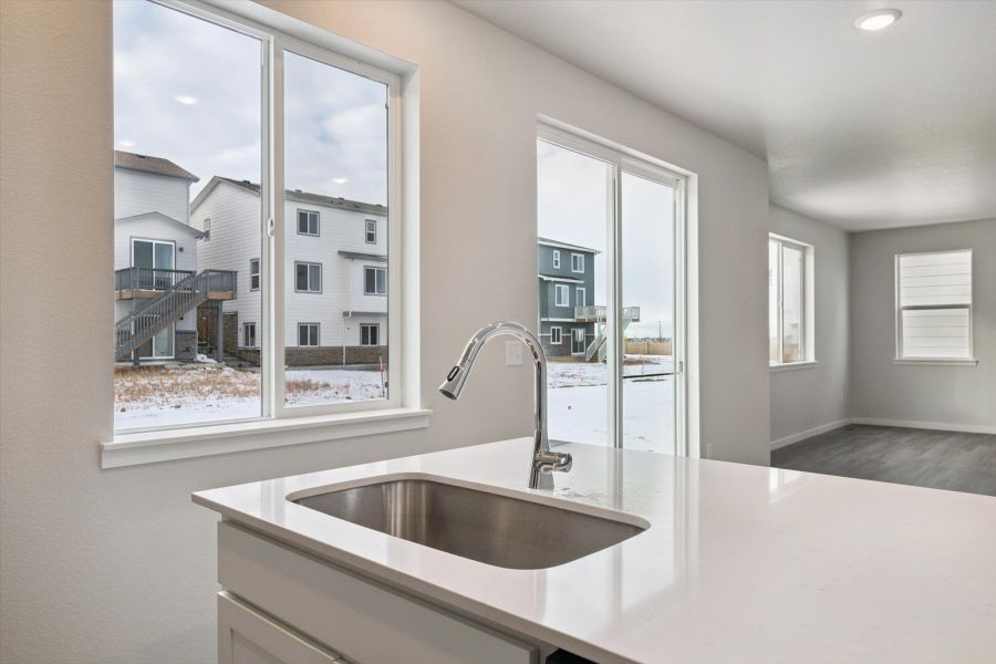 A kitchen with a sink and a window.