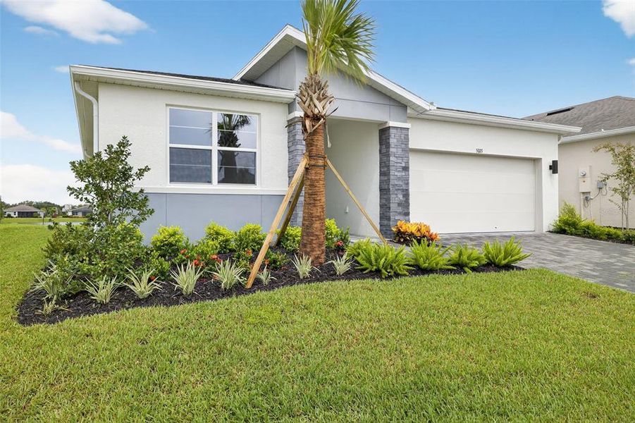 Front exterior of a new home in Windwater, Parrish, FL, highlighting curb appeal (Image 19).