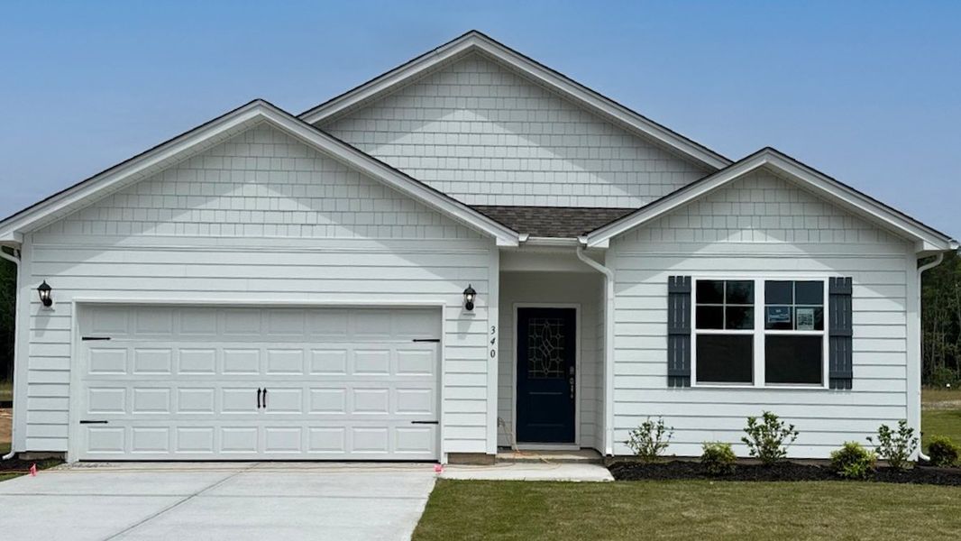 Front exterior of a new home in Sease's Pond, Gilbert, SC, highlighting curb appeal (Image 1).