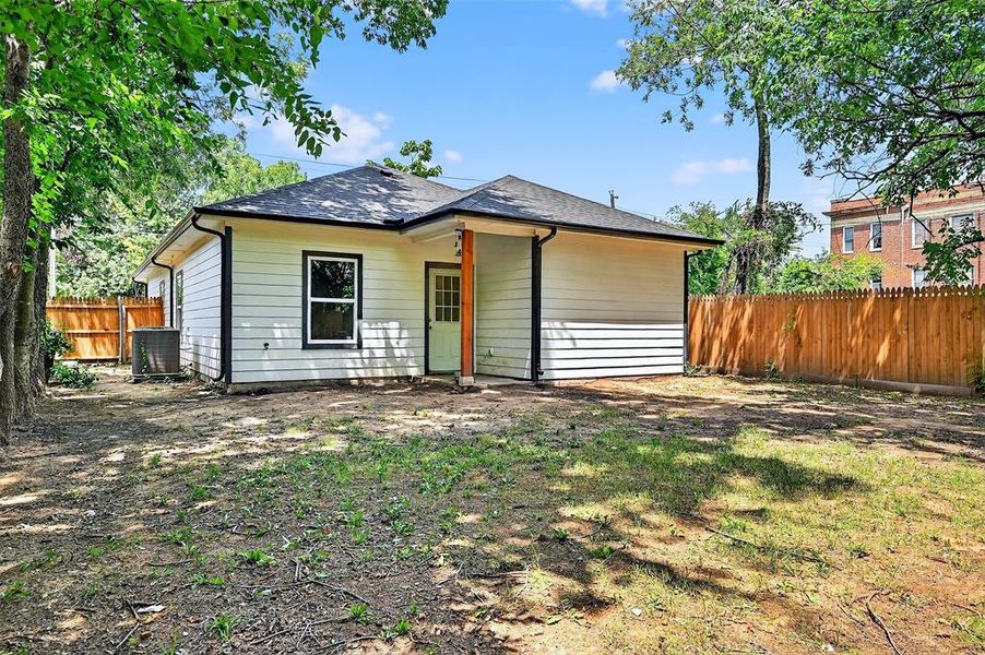 Rear view of property featuring a fenced backyard and a shingled roof Rear view of property featuring a fenced backyard and a shingled roof