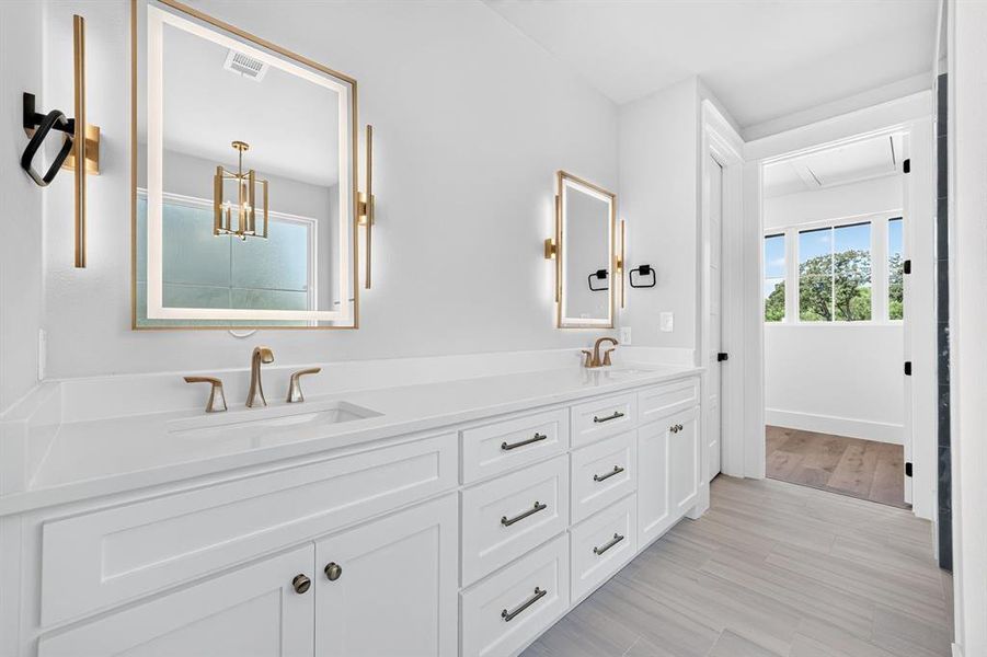 Spa master bath featuring double vanity with premium finishes, anti-fog LED mirrors with integrated defrost technology. Spa master bath featuring double vanity with premium finishes, anti-fog LED mirrors with integrated defrost technology.
